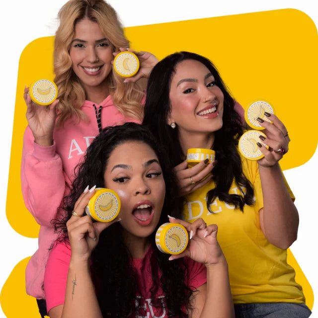 ADEUS Banana Glow Duo with dark spot corrector cream and radiance renewal scrub, shown with models holding the skincare kit.